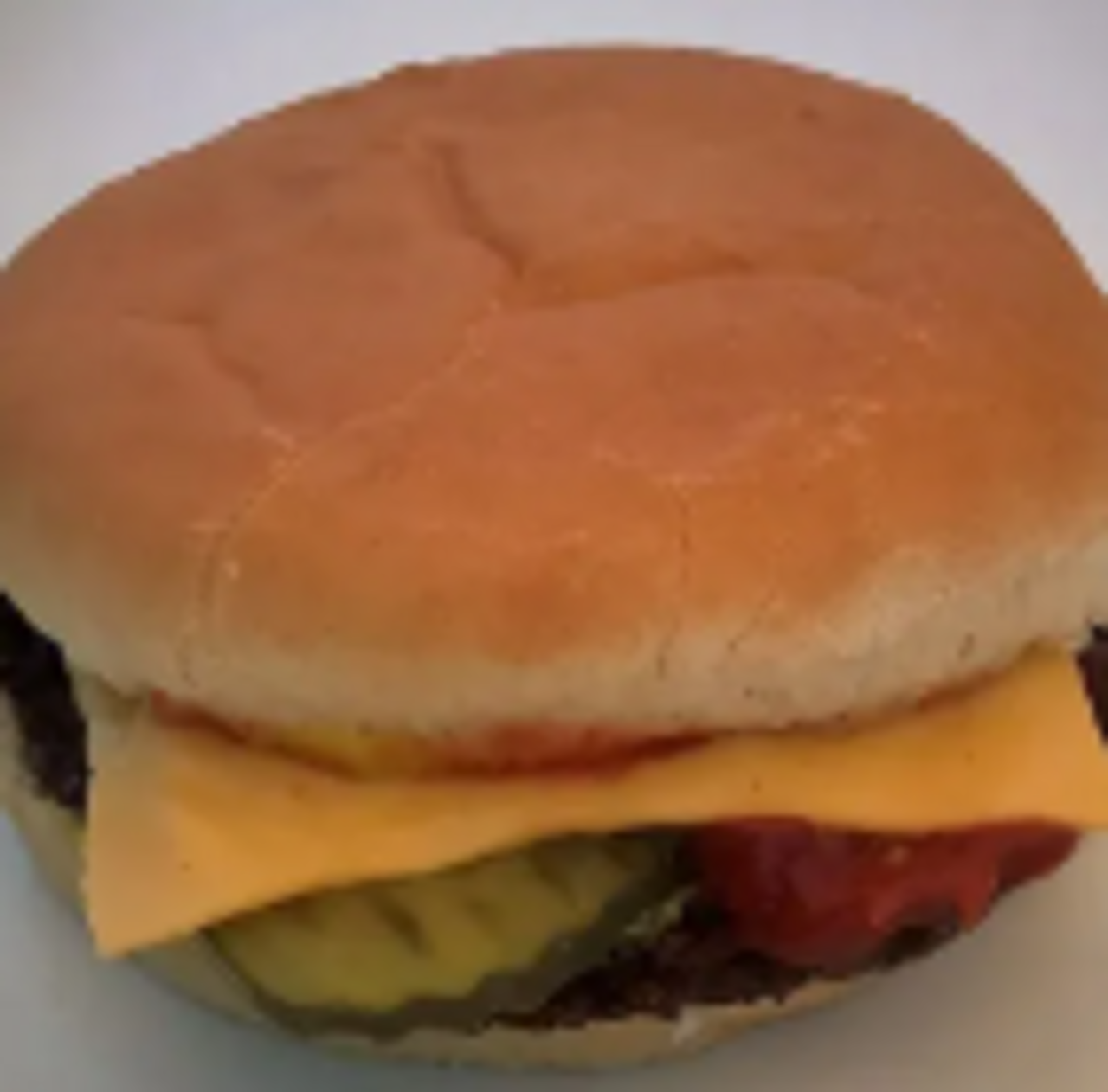 Topped with ketchup, mustard, pickle, & a slice of cheese
